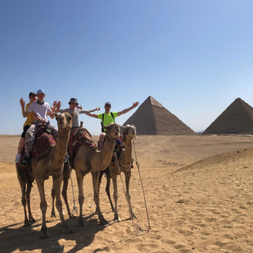 Family riding on camels in Egypt