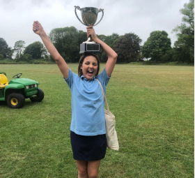 tegan holding trophy at school